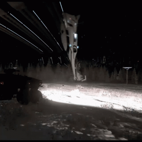 Car Driving on Snowy Road at Night