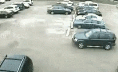 Car Driving Through Parking Lot