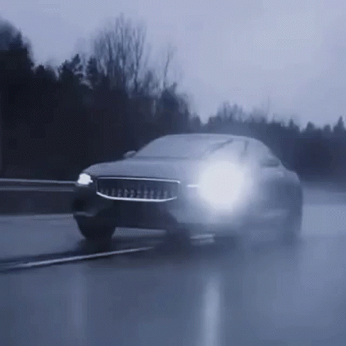 Car Driving Wet Road At Night With Headlights GIF