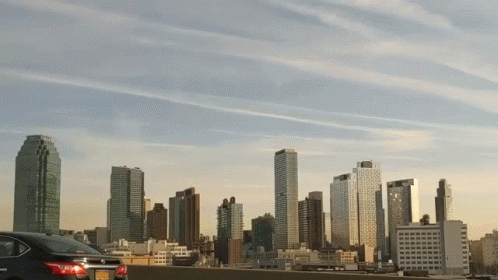Car Parked in Front of City Skyline