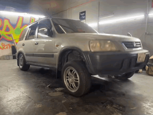 Car Parked in Garage With Graffiti A