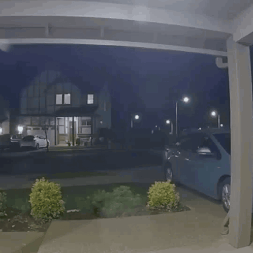 Car Parked Under Covered Porch At Night GIF