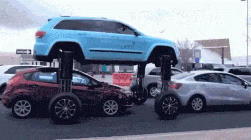 Car With Expandable Wheels In Traffic GIF