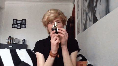 Carl Bradburry Shows Bottle Black Liquid GIF