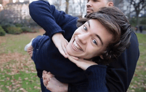Carrying Another Man on Back Smiling