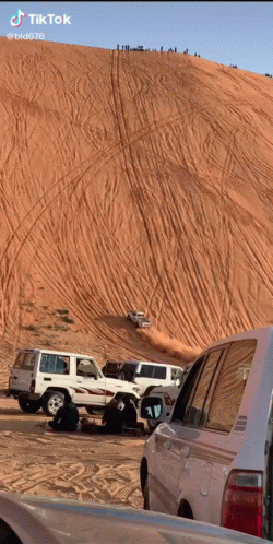 Cars Driving Down Sand Dune