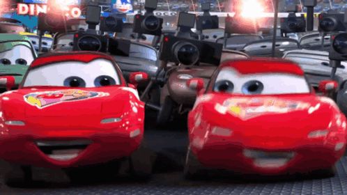 Cars Driving Past Dinoco Sign