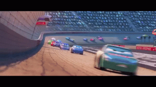 Cars Racing On A Track With A Sign That Says Motor Speedway On It GIF