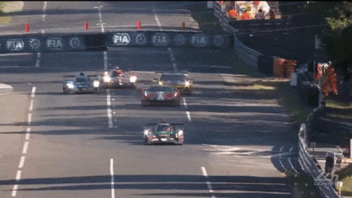 Cars Racing on Track with FIA Banner