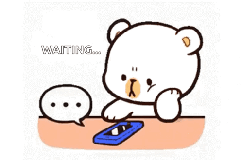 Cartoon Bear Sitting At Table With Cell Phone GIF