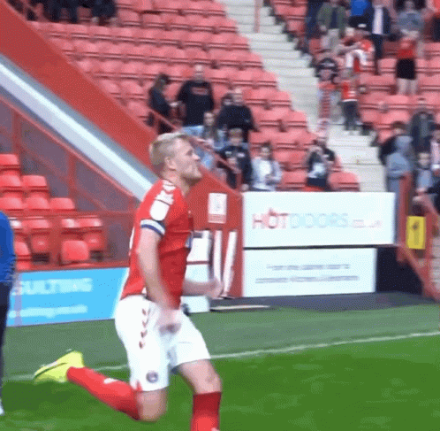 Cartoon Cat In Red Shirt Jumping On Soccer Field GIF