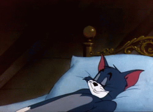 Cartoon Cat Lying in Bed with Blue Pillow