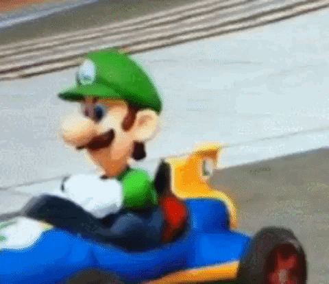 Cartoon Character Driving Toy Car On Race Track GIF