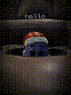 Cartoon Character In Santa Hat Peeking From Box GIF