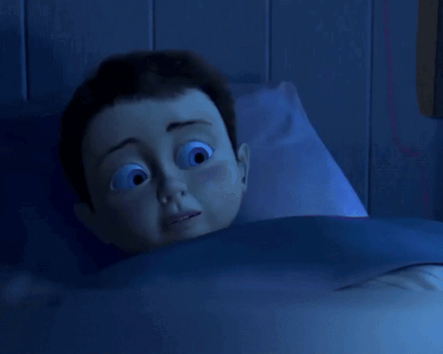 Cartoon Character Laying in Bed With Blue Blanket