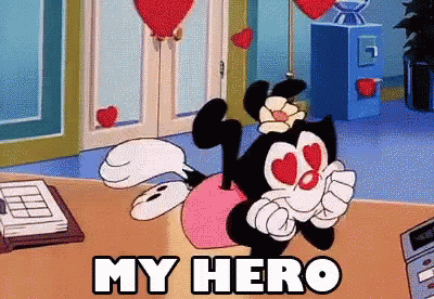 Cartoon Character Saying My Hero Sitting On Table GIF
