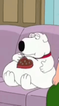 Cartoon Character Sitting on Couch Eating Heart Shaped Chocolate