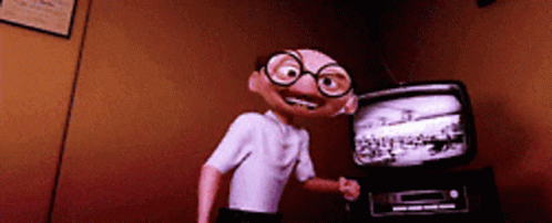 Cartoon Character With Glasses In Front Of TV GIF