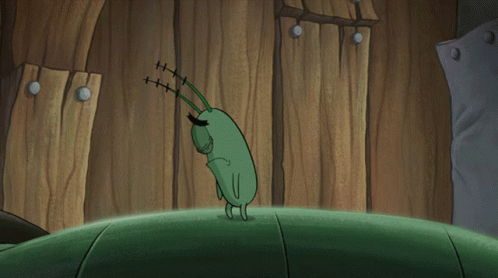 Cartoon Character With Red Eye on Green Surface