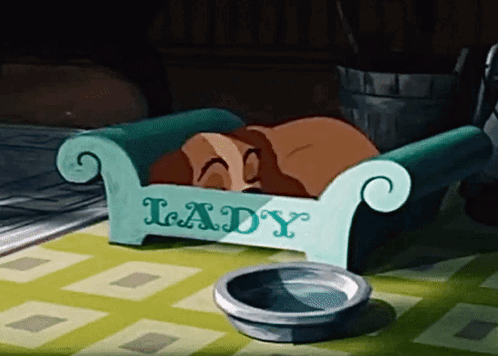Cartoon Dog Sleeping In 'Lady' Bed GIF