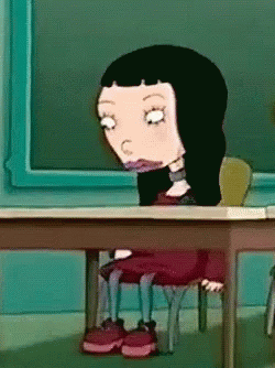 Cartoon Girl With Black Hair at Desk in Front of Blackboard