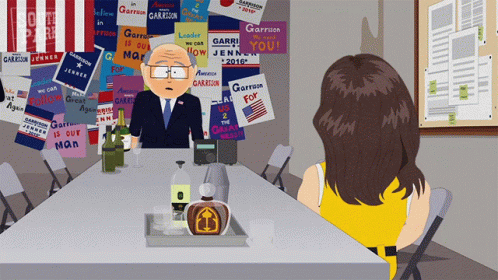 Cartoon Man Sitting At Table With Sign Garrison GIF