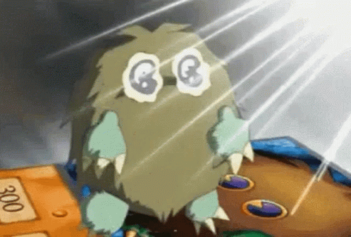 Cartoon Monster With Big Eyes and Sharp Teeth on Table