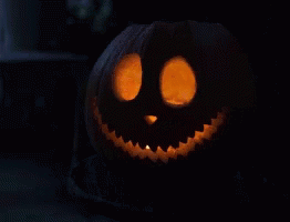 Carved Halloween Pumpkin with Smiling Face and Glowing Eyes