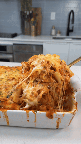 Casserole Dish With Pasta And Cheese And Spoon GIF