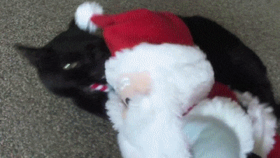 Cat Biting Santa Claus Candy Toy GIF