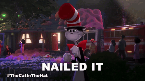 Cat in Red and White Hat Says Nailed It in Front of Fire Truck