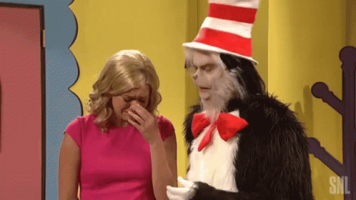 Cat In The Hat Is Standing Next To A Woman Who Is Covering Her Face GIF