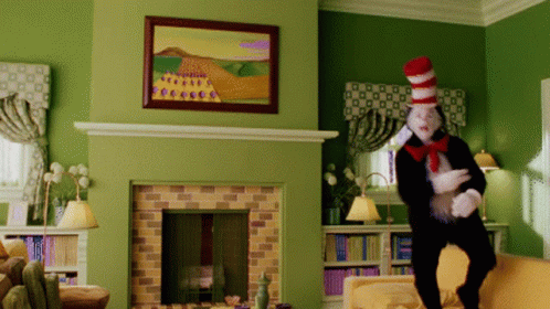 Cat in the Hat Standing by Fireplace