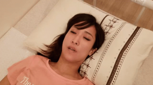 Cat Lying on Bed With Cash