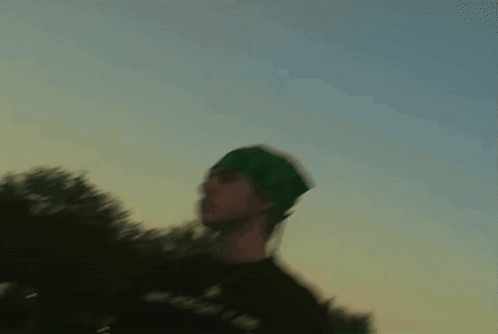 Cat Playing With Yellow Flower In Front Of Clock Saying 10:08 GIF