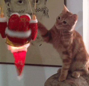 Cat Rolling Santa Claus Toy GIF