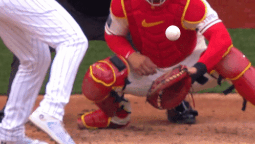 Catcher in Red Nike Uniform Catches Ball