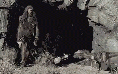 Caveman Kicked The Baby Dinosaur GIF