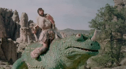 Caveman Rides Above Huge Creepy Creature GIF