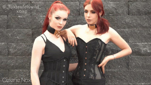 Celene Nox Is Standing Next To Another Woman In A Corset GIF