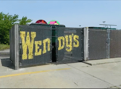Chain Link Fence With Wendy's Written On It