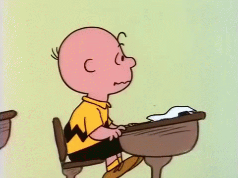 Charlie Brown in Classroom With Hands Together