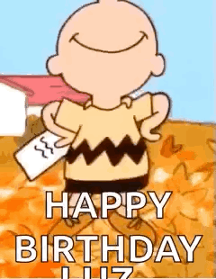Charlie Brown Is Holding A Piece Of Paper In His Hand And Smiling . GIF