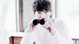 Cheerful Kim Jinwoo Looking Thru Binoculars GIF