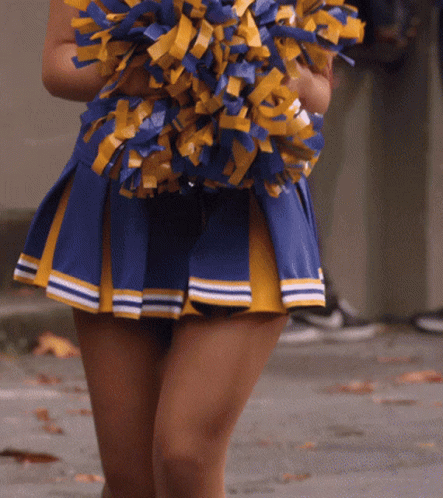 Cheerleader In Blue And Yellow Skirt Holding Pom Poms GIF