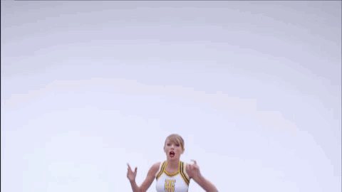 Cheerleader in Crop Top and Blue Skirt Jumping