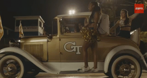 Cheerleader in Front of Car Saying GT