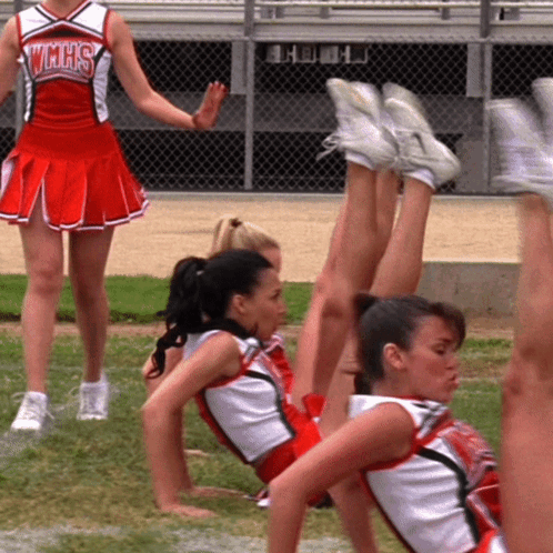 Cheerleader In VMHS Uniform Next To Group GIF