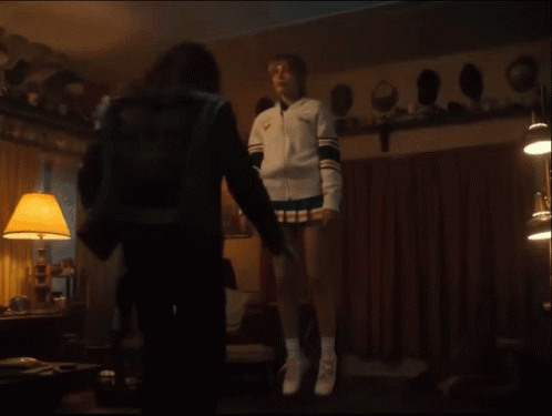 Cheerleader in White Jacket and Shorts Flying