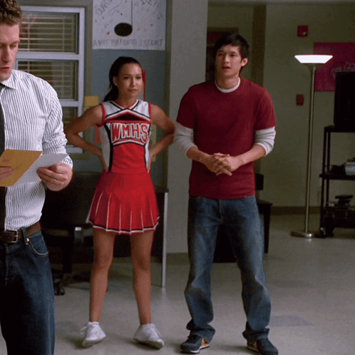 Cheerleader in WMHS Uniform Next to Man in Red Shirt